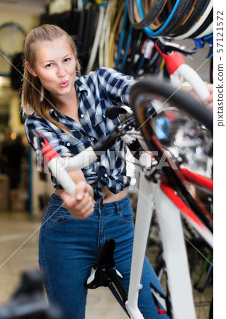 Smiling girl is standing with bicycle Smiling girl is standing with bicycle 57121572