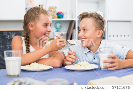 Friends are feed each other during dinner Friends are feed each other during dinner 57121676