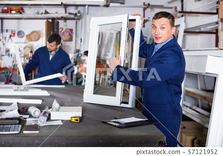 Workmen inspecting PVC manufacturing output in workshop Workmen inspecting PVC manufacturing output in workshop 57121952