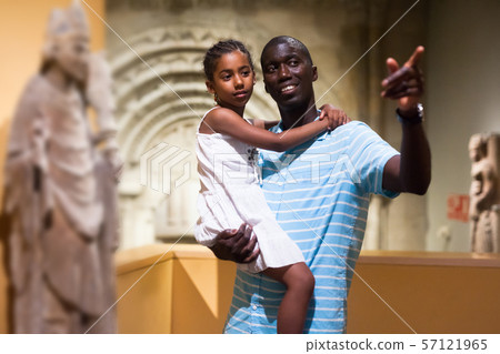 Man and his daughter looking at medieval art 57121965