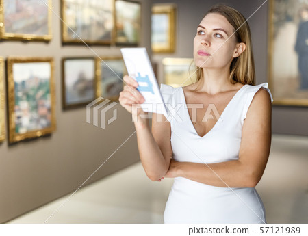 Woman visiting painting exhibition 57121989