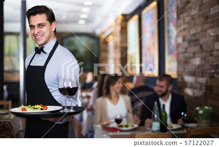 Waiter posing in restaurant Waiter posing in restaurant 57122027