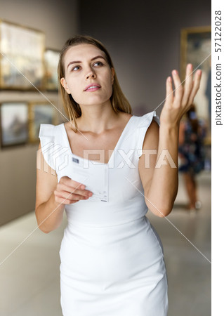 Woman visiting painting exhibition Woman visiting painting exhibition 57122028