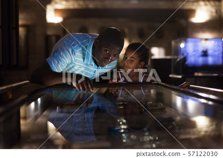 Father and daughter looking at stands with exhibits Father and daughter looking at stands with exhibits 57122030