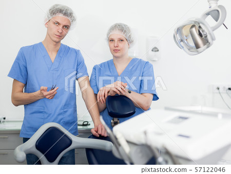 Portrait of professional dentists standing in modern medical office Portrait of professional dentists standing in modern medical office 57122046