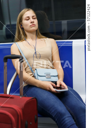 Thoughtful woman traveling in subway Thoughtful woman traveling in subway 57122424