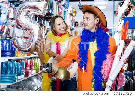 Man with girlfriend trying on cowboy hat and smiling 57122720