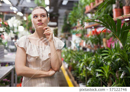 Portrait of woman chooses flowers in flower shop Portrait of woman chooses flowers in flower shop 57122746