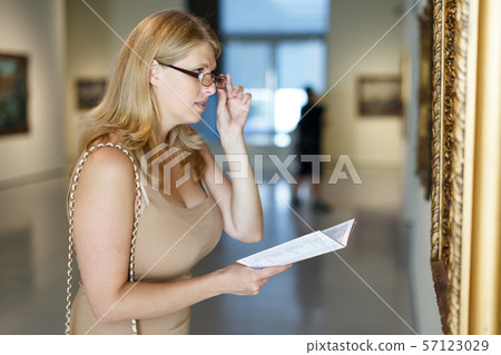 Woman with poor eyesight visiting museum Woman with poor eyesight visiting museum 57123029