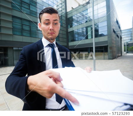 Professional manager is standing upset near office Professional manager is standing upset near office 57123293