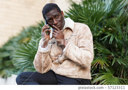 Displeased man talking on smartphone 57123311