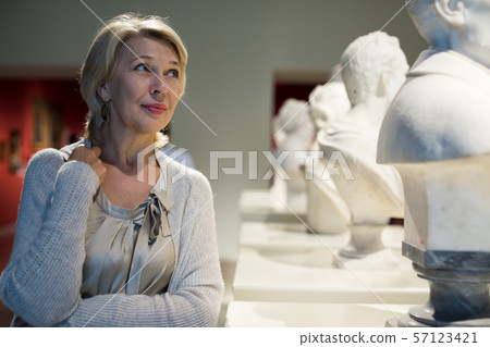 female looking at artwork sculpture female looking at artwork sculpture 57123421