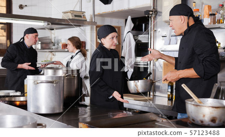 Chef male dissatisfied with the work of girl help Chef male dissatisfied with the work of girl help 57123488