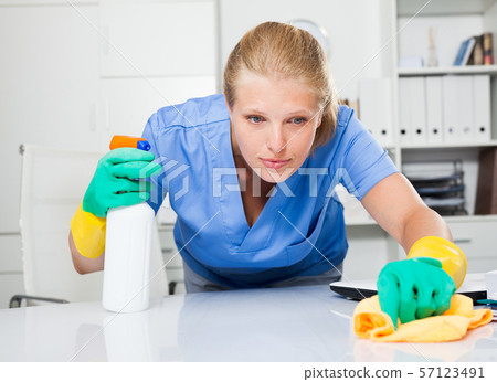 Janitor in latex gloves cleaning workplace Janitor in latex gloves cleaning workplace 57123491
