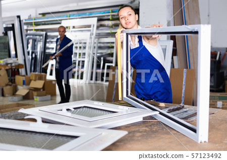 woman using measuring tape in her work in production of pvc windows woman using measuring tape in her work in production of pvc windows 57123492