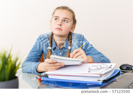 Girl doing herself her home task 57123500