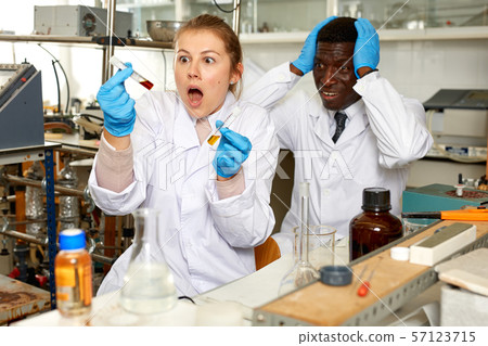 Emotional lab technician woman and man with tubes are worried Emotional lab technician woman and man with tubes are worried 57123715