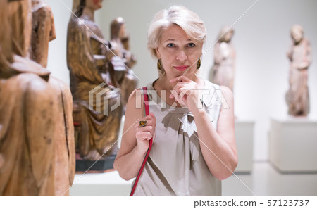 visitor female near sculpture in the museum 57123737