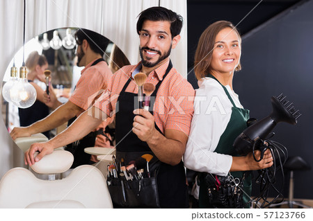 Smiling male makeup artist and woman hairdresser 57123766