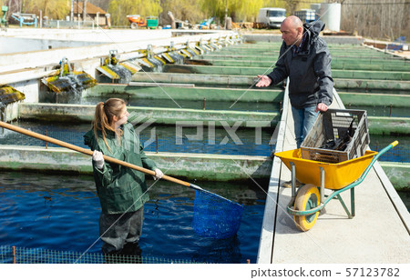 Male and female catching fish from reservoir Male and female catching fish from reservoir 57123782
