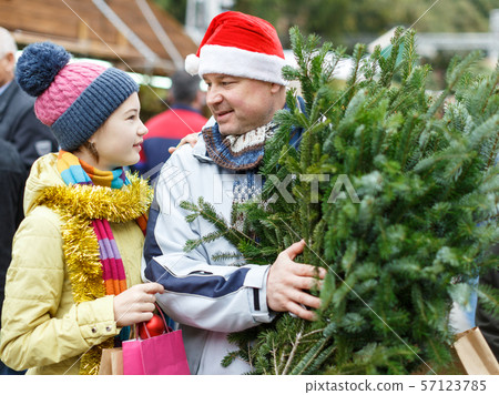 Girl and father with Christmas tree Girl and father with Christmas tree 57123785