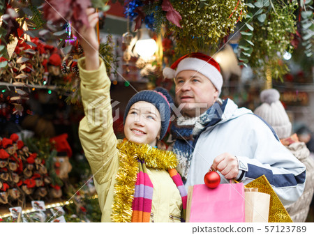 Girl with father shopping on Christmas market Girl with father shopping on Christmas market 57123789