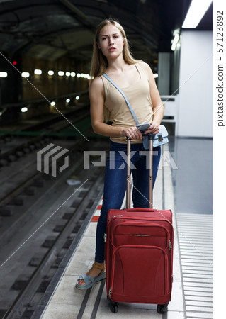 Woman on underground platform waiting train 57123892