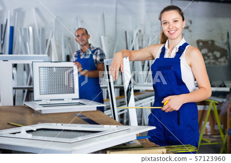 Girl working in workshop for assembling plastic windows Girl working in workshop for assembling plastic windows 57123960