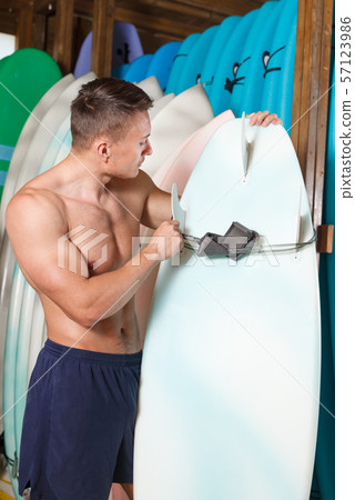 male surfer choose surfboard 57123986