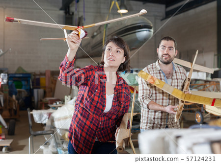 Couple having fun with plane models 57124231