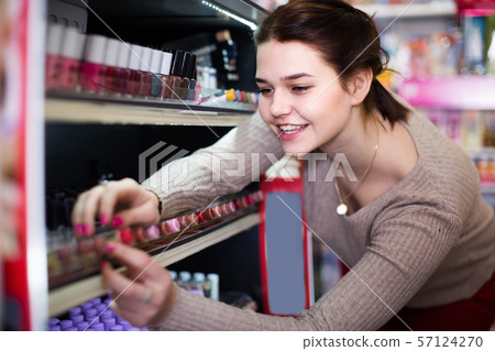 female customer looking for nail polish in cosmetics shop female customer looking for nail polish in cosmetics shop 57124270