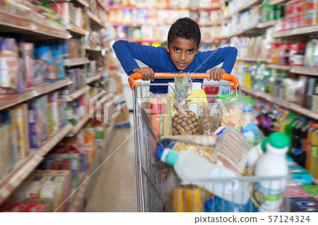 Casual African American boy carrying purchases 57124324
