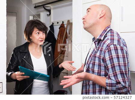 Woman conducting survey among people at door 57124327