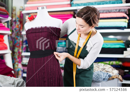 Tailor working at dress 57124386