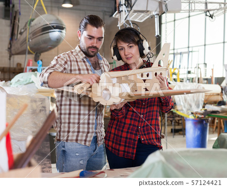 Couple modeling airplanes Couple modeling airplanes 57124421
