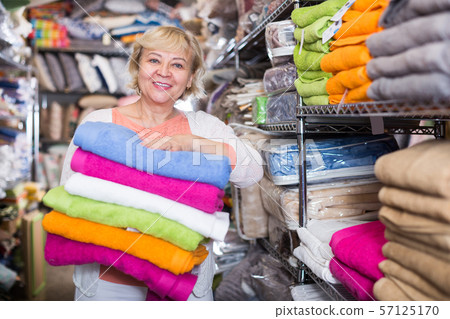 mature woman with a set of towels in the shop mature woman with a set of towels in the shop 57125170