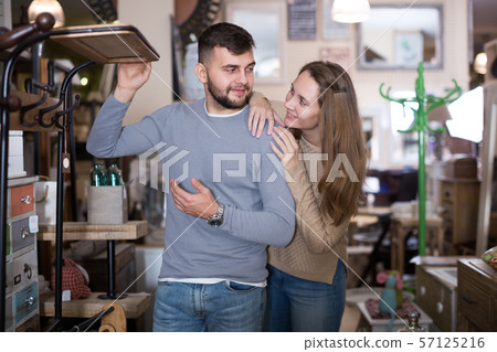Couple looking for hallstand in shop Couple looking for hallstand in shop 57125216
