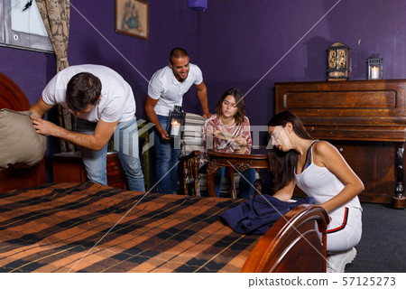 Young adults in escape room with antique furnitures Young adults in escape room with antique furnitures 57125273