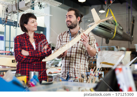 Team of happy enthusiasts working in workshop Team of happy enthusiasts working in workshop 57125300