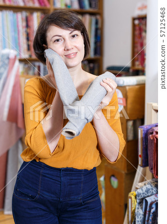 Brunette touching face with fabric Brunette touching face with fabric 57125468