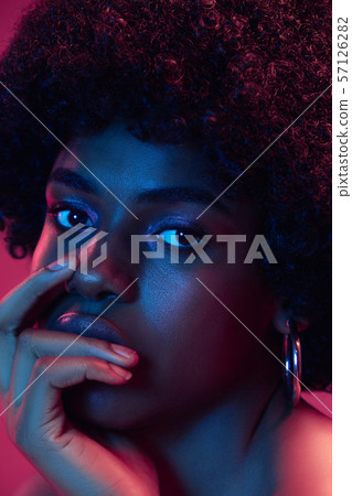 Portrait of female high fashion model in neon light 57126282