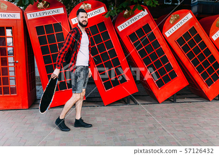 man with a beard, a man holding a skateboard in man with a beard, a man holding a skateboard in 57126432