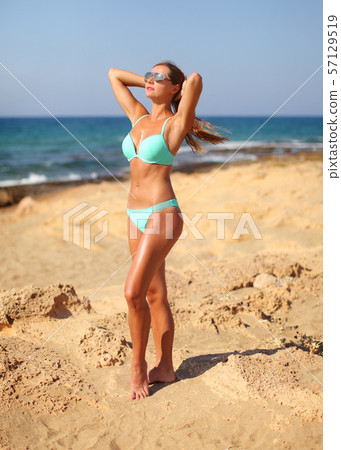 Young athletic woman with cyan bikini and Young athletic woman with cyan bikini and 57129519
