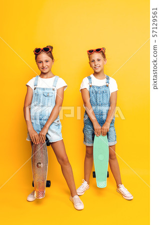 Two teenagers, stylish children posing with Two teenagers, stylish children posing with 57129561