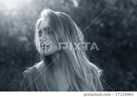 Attractive sensual woman posing in the park on sunny autumn day. 57129965