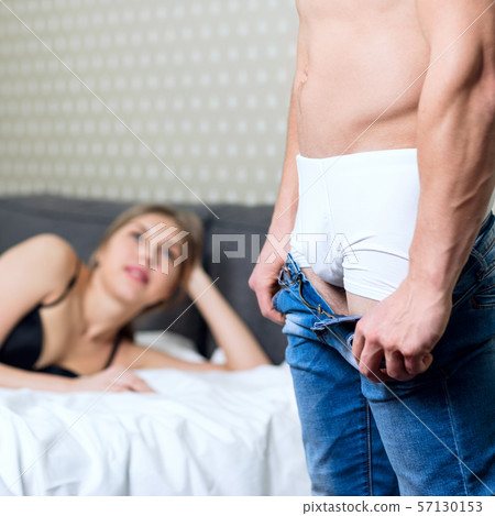 Woman waiting her boyfriend when he takes off his jeans. 57130153