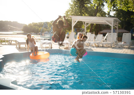 Boyfriends jumping into water while chilling near pool with women Boyfriends jumping into water while chilling near pool with women 57130391