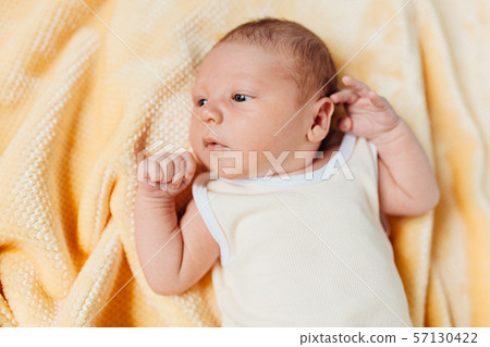a newborn baby, a beautiful baby who smiles, in a a newborn baby, a beautiful baby who smiles, in a 57130422