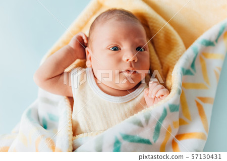 a newborn baby, a beautiful baby who smiles, in a 57130431