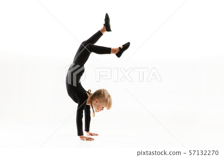 Female little gymnast practicing isolated on white background Female little gymnast practicing isolated on white background 57132270